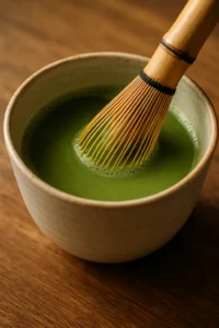 Whisking matcha powder into warm water